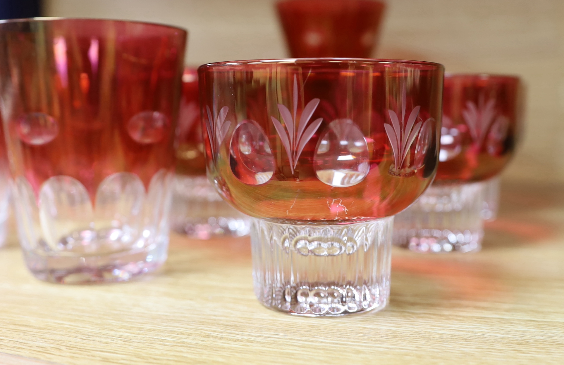 A quantity of cranberry flashed glasses including a set of five, the largest 18cm high